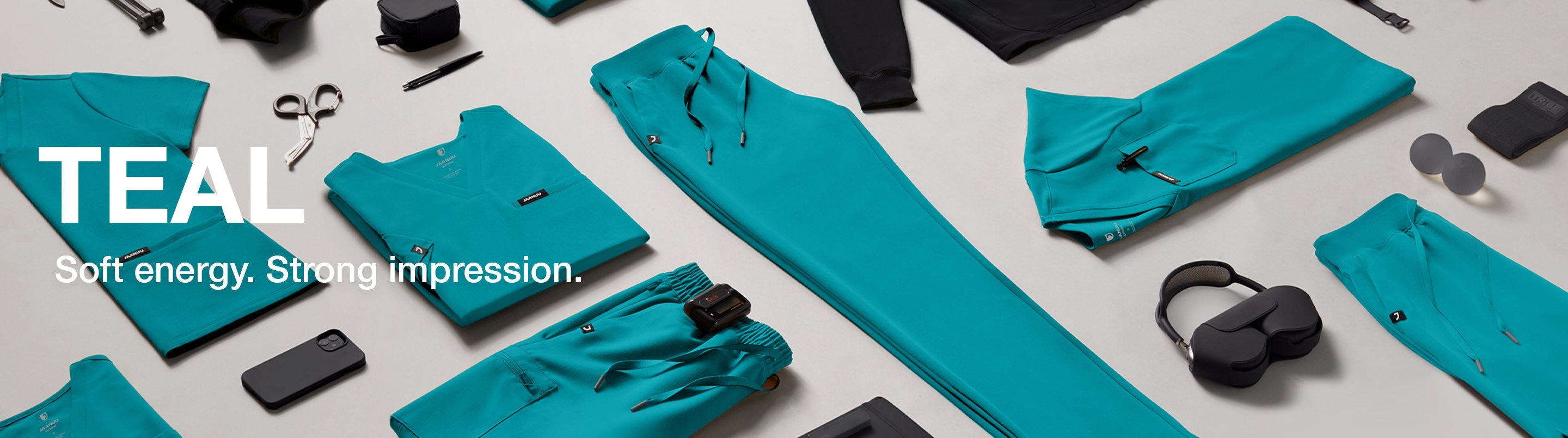 Photo of scrubs folded and in a grid layout with text, "Teal: Soft energy. Strong impression."