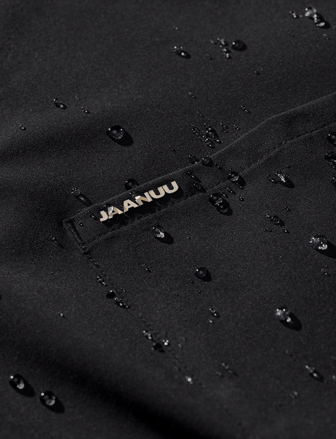 Closeup image of Jaanuu scrub fabric with PFC-free water repellent treatment. Water droplets are sitting on the scrub with out soaking through.