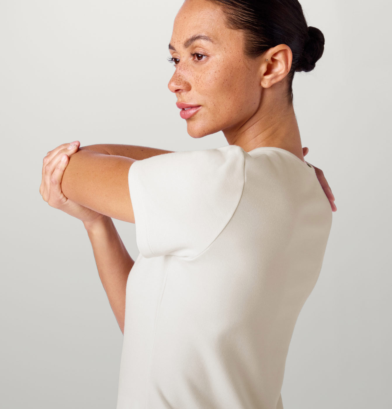 A woman wearing Frost colored scrub top.