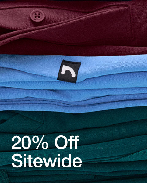 A stack of folded scrubs and scrub jackets stacked on top of each other. Image has text, "20% Off Sitewide". - Men Nav Tile