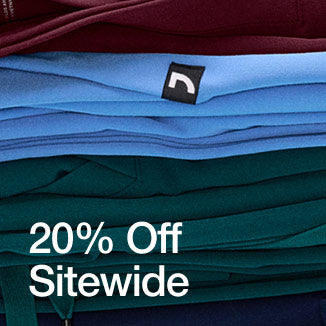 A stack of folded scrubs and scrub jackets stacked on top of each other. Image has text, "20% Off Sitewide". - Men Nav Tile