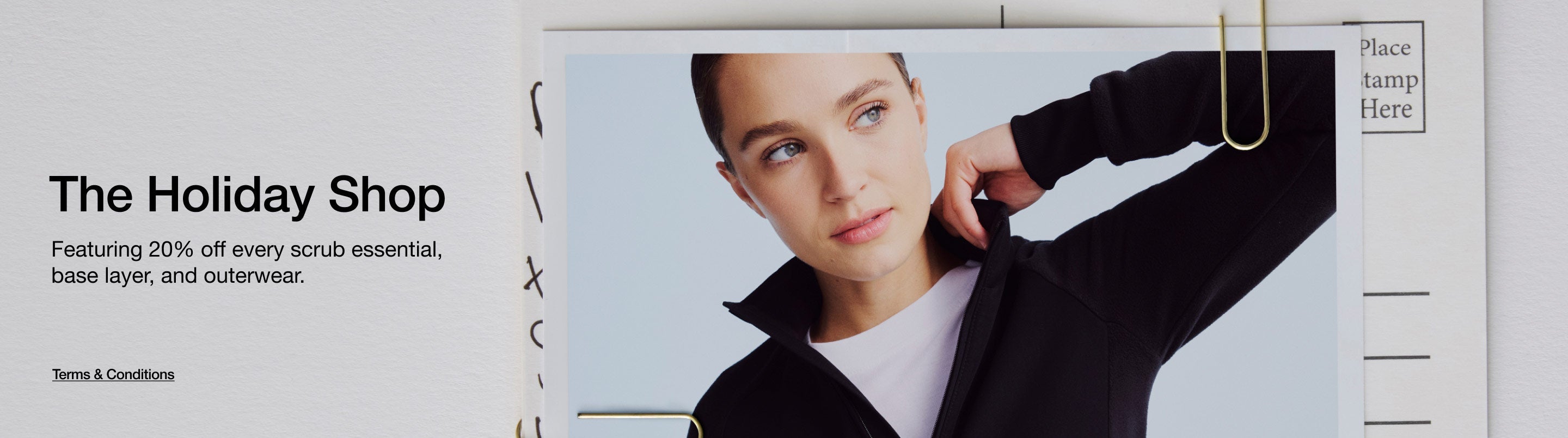 Image of a healthcare provider wearing scrubs and a scrub jacket. Image has text, "The Holiday Shop: Featuring 20% off every scrub essential, base layer, and outerwear. Click to view Terms and Conditions."