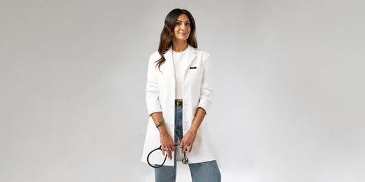 Dr. Neela wearing a lab coat while holding a stethosope.