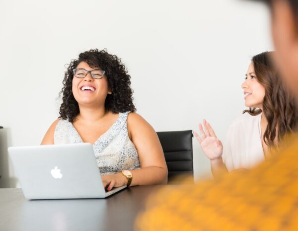 Woman sitting at computer laughing
