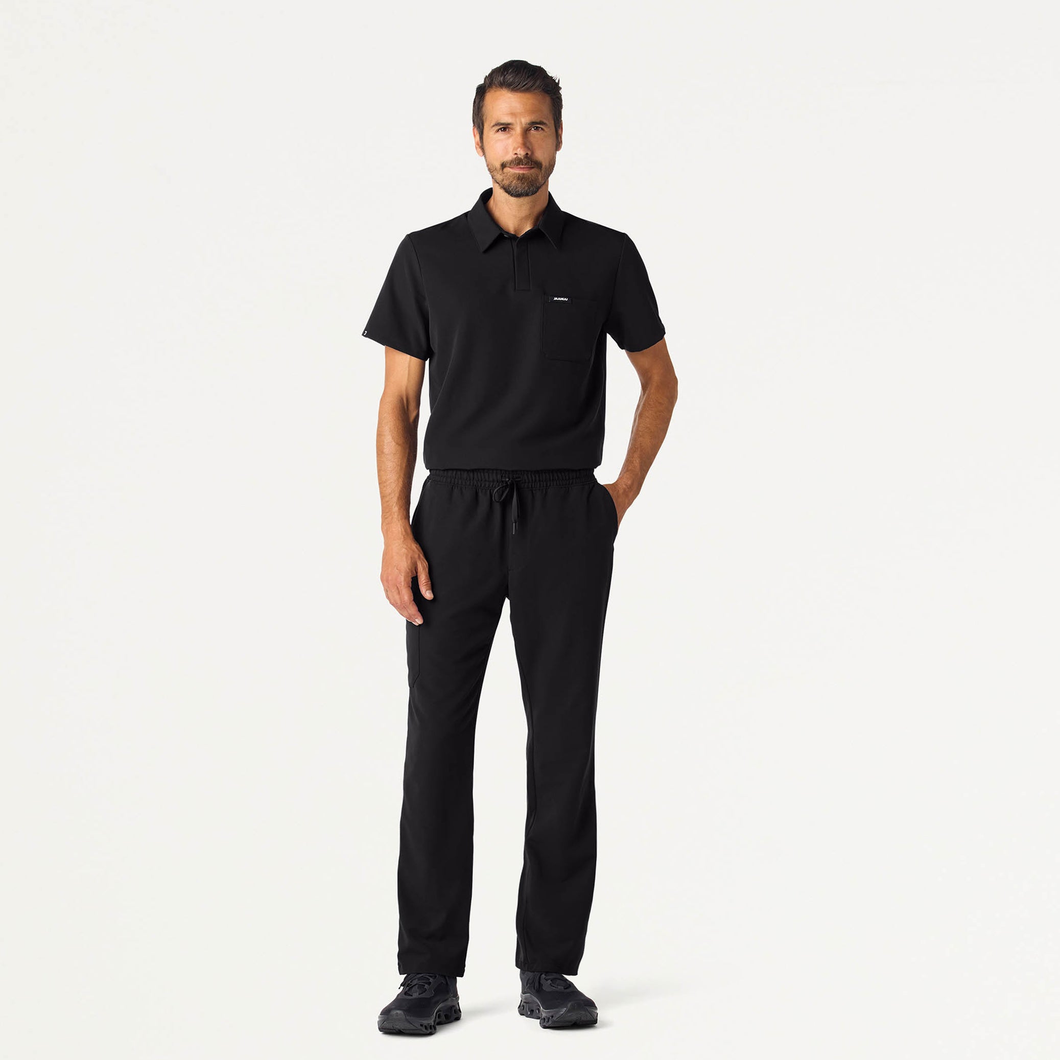 Man wearing a Black scrub top and scrub pant